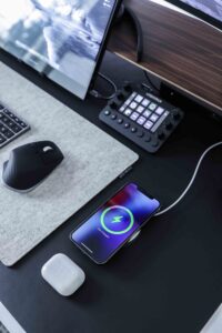 A phone charging on a person's desk