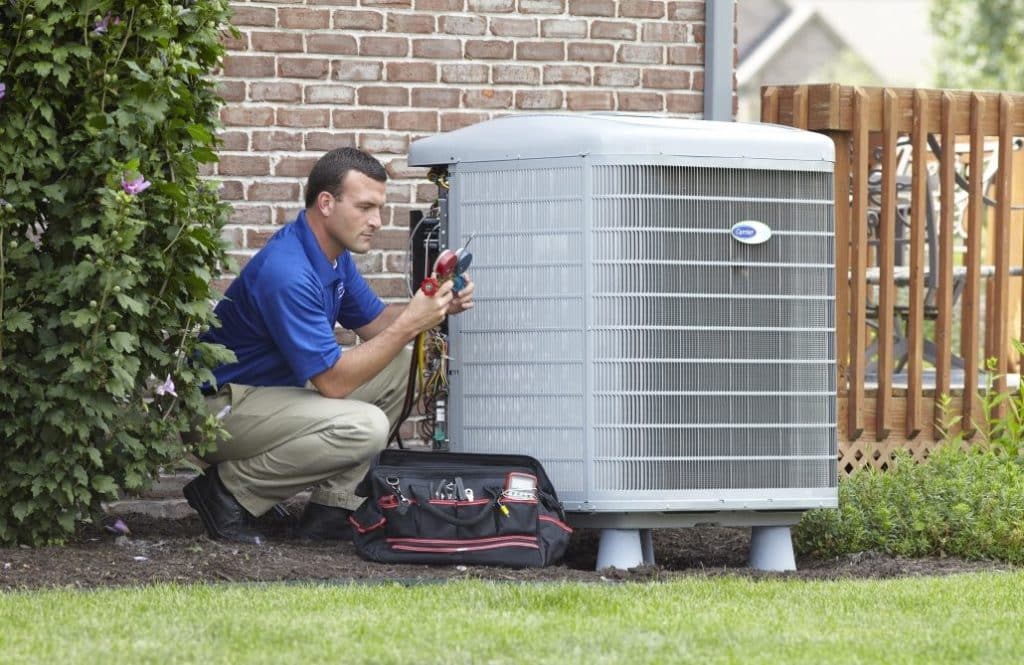 HVAC technician installing new air conditioning unit