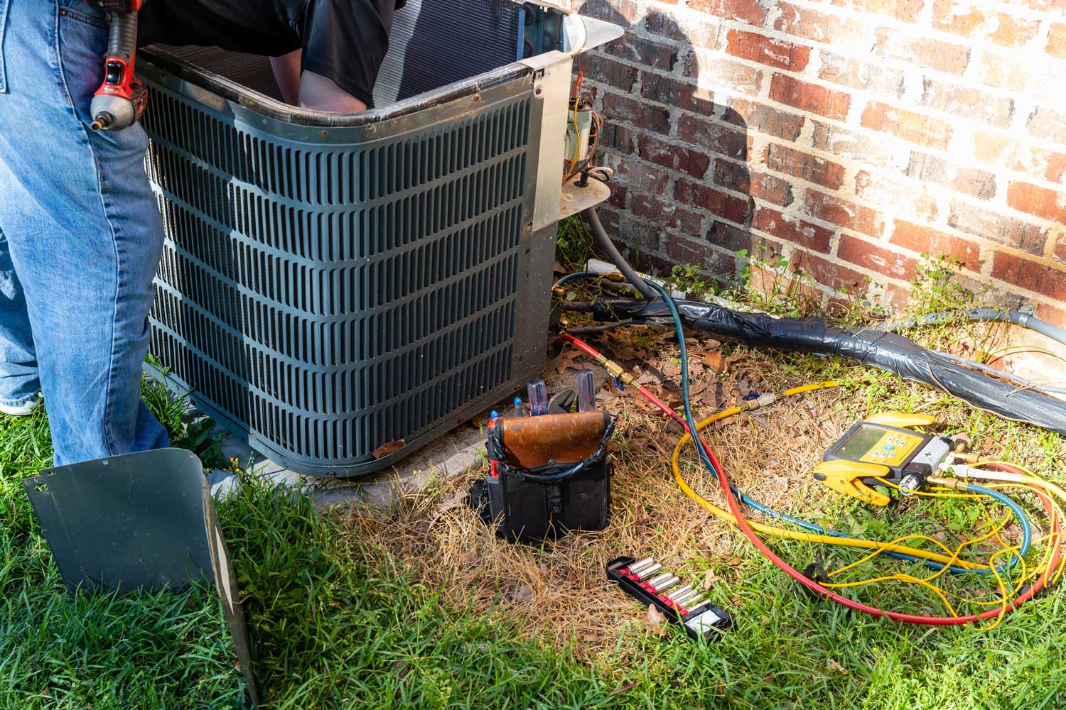 technician repairing heating system in the fall