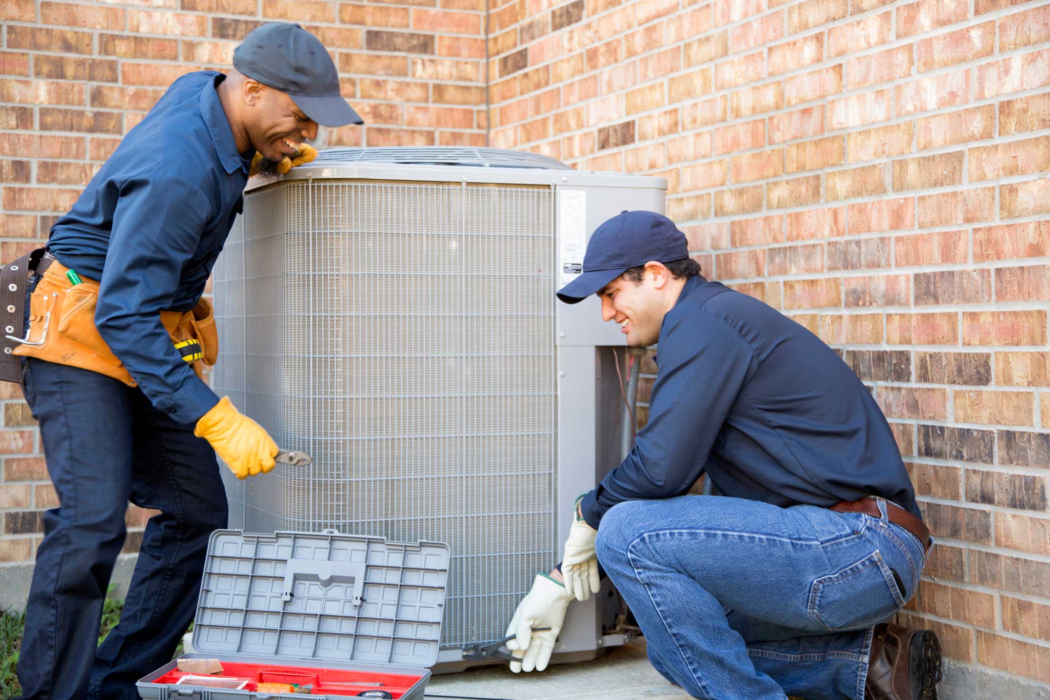 technicians installing an HVAC system