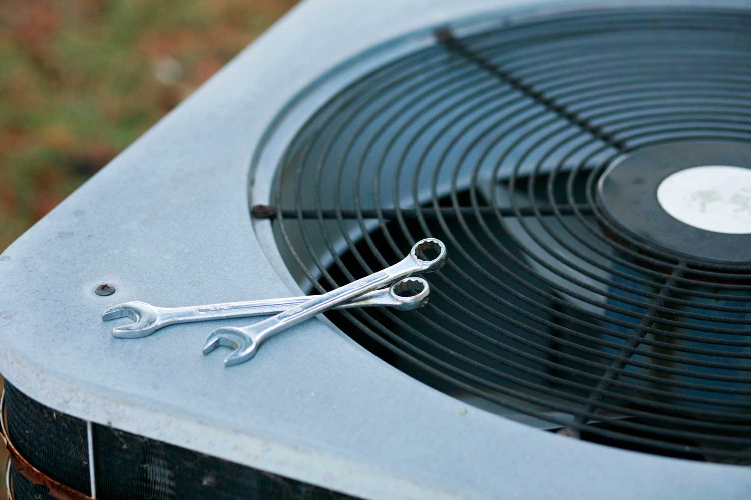 tools sitting on top of a heat pump unit during HVAC repair